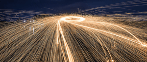 silhouette-of-man-making-a-circle-of-sparks-at-night-crop-u23890